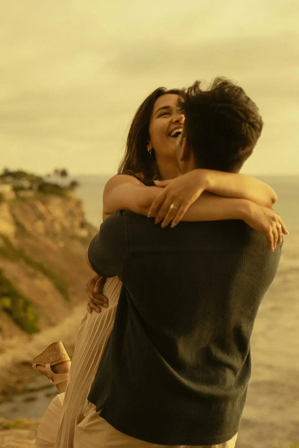 Nihal lifting Rakshana off her feet, both laughing.